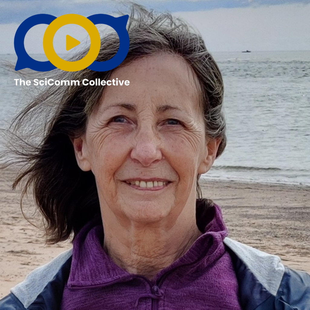 An older white woman on a sand and pebble beach with ocean in the background under a grey sky, wind blowing her hair. The SciComm Collective logo in the foreground