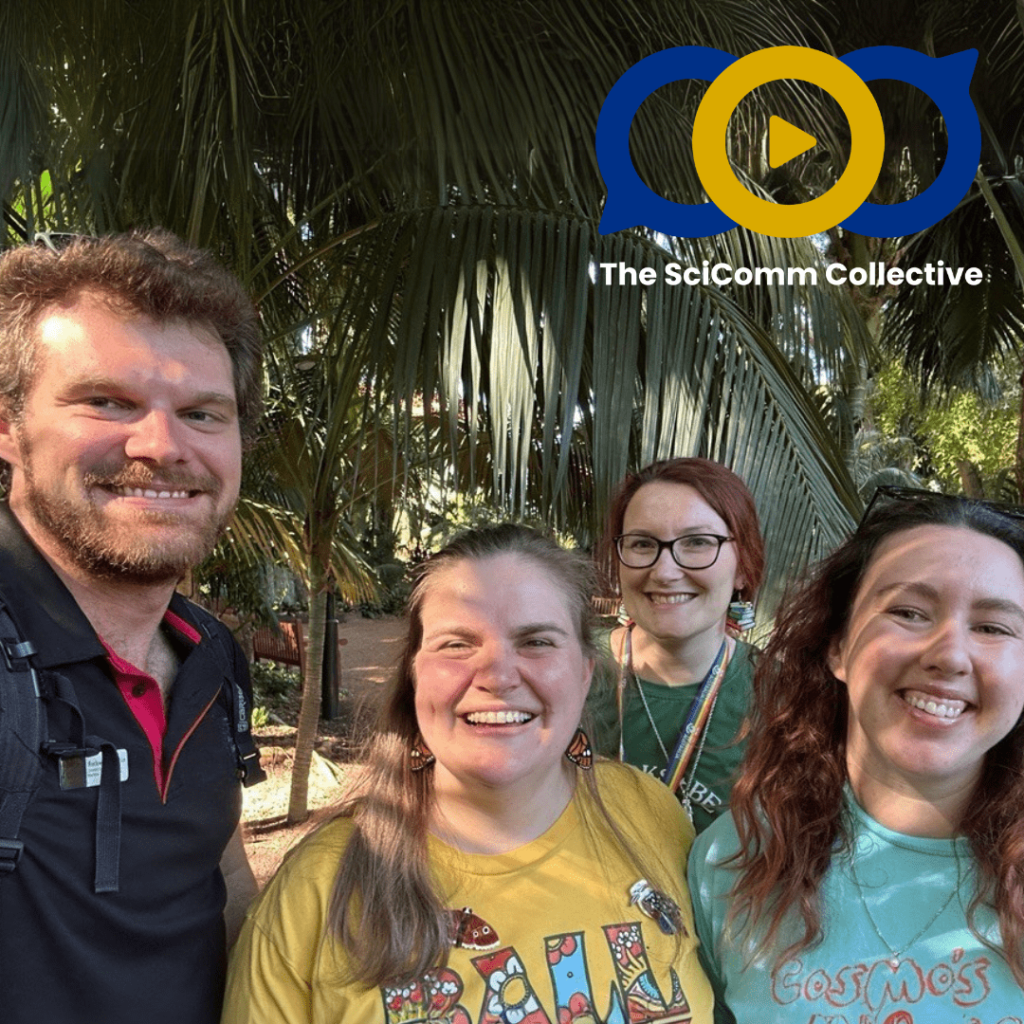 A white man and three white women smiling at the camera as a group under a palm tree with dappled sunlight on them.